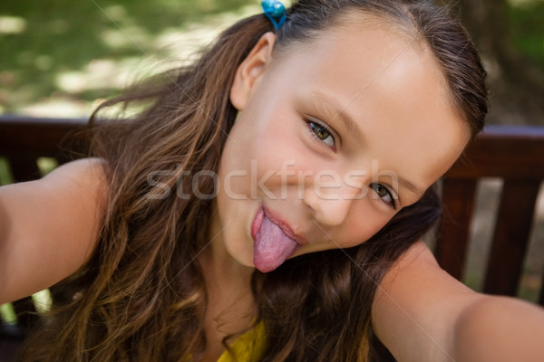 Portrait of playful girl sticking out tongue Stock photo © wavebreak_media