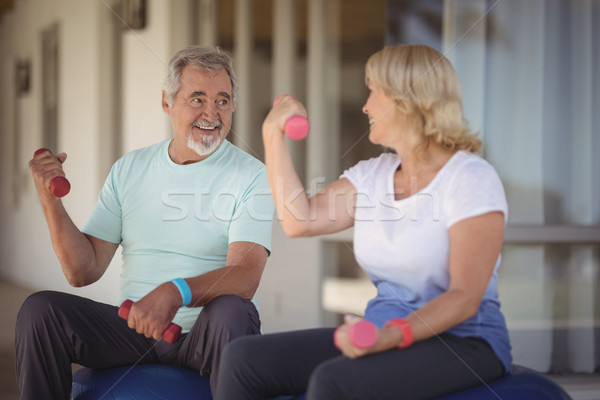 Senior couple sitting on fitness balls with dumbbells Stock photo © wavebreak_media