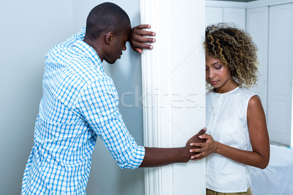 Upset couple standing on opposite sides of the wall Stock photo © wavebreak_media