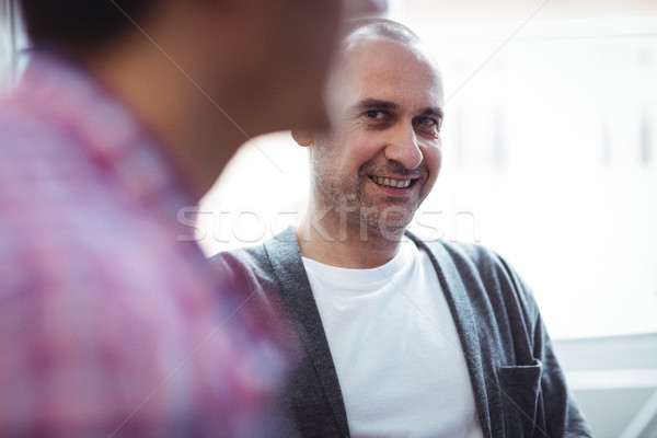 üzletember néz munkatárs mosolyog kreatív iroda Stock fotó © wavebreak_media