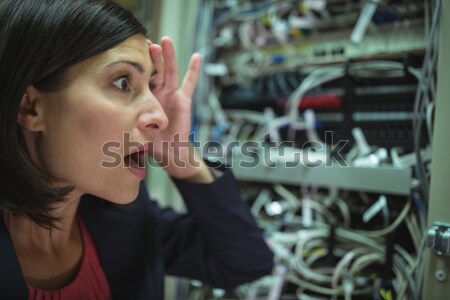 Technician maintaining record of rack mounted server on clipboard Stock photo © wavebreak_media