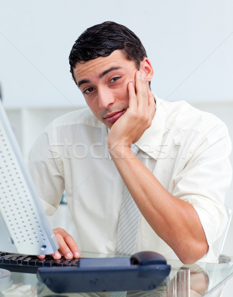 Bored Hispanic businessman at his desk Stock photo © wavebreak_media