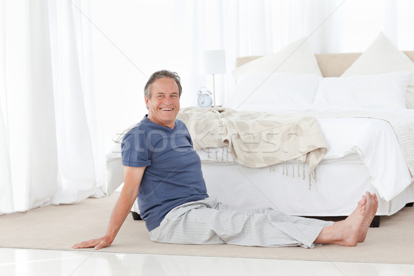 Mature man stretching in his bedroom Stock photo © wavebreak_media