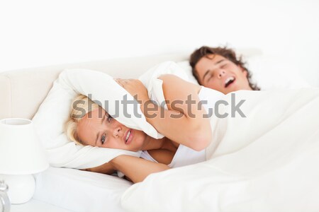 Angry woman awaken by her husband's snoring in their bedroom Stock photo © wavebreak_media