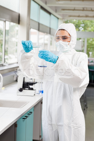 Portrait of a protected female scientist pouring liquid in a Erlenmeyer flask in a laboratory Stock photo © wavebreak_media