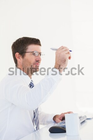 Portrait of a businessman touching something against a white background Stock photo © wavebreak_media
