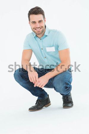 Portrait of a man squatting against a white background Stock photo © wavebreak_media