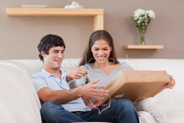 Young couple opening parcel on the couch Stock photo © wavebreak_media