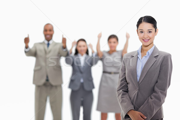 Close-up of a businesswoman smiling with co-workers approving in the background Stock photo © wavebreak_media