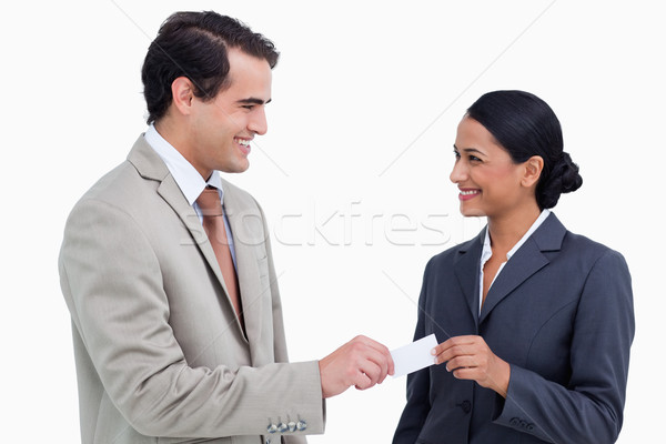 Smiling business people exchanging business cards against a white background Stock photo © wavebreak_media