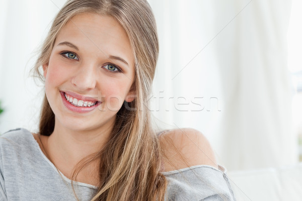 A close up of a smiling girl as she looks at the camera  Stock photo © wavebreak_media