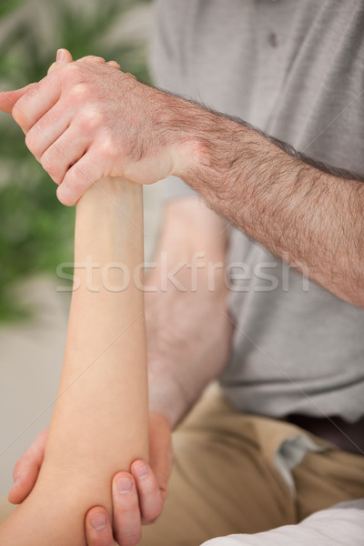 Ankle and elbow of a patient being manipulated in a medical room Stock photo © wavebreak_media
