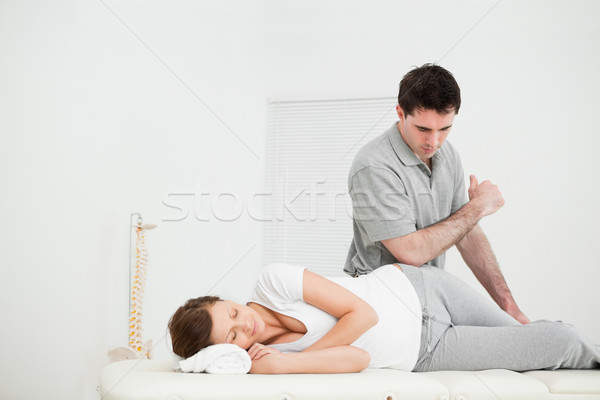 Woman lying on the side while being massaging by her doctor in a medical room Stock photo © wavebreak_media