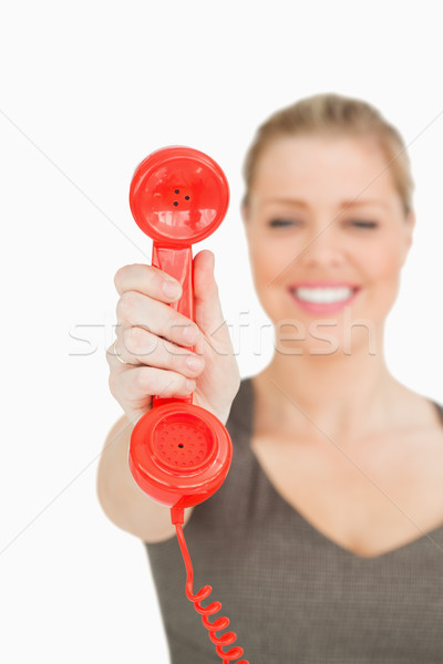 Blurred woman showing a retro phone against white background Stock photo © wavebreak_media