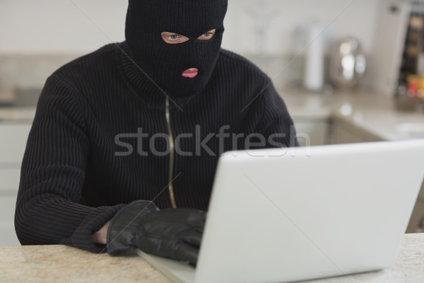 Hackers desconhecido laptop sessão cozinha casa Foto stock © wavebreak_media