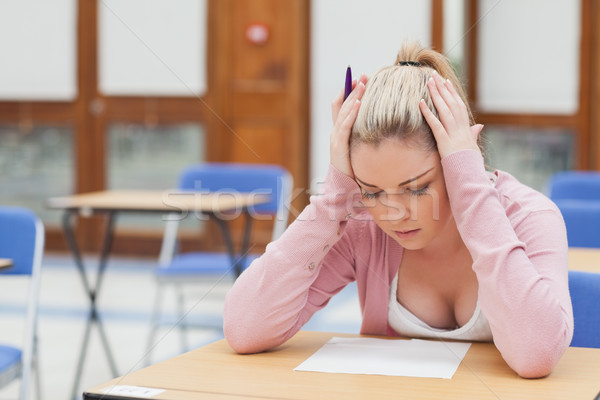Woman looking at exam paper anxiously in exam hall Stock photo © wavebreak_media