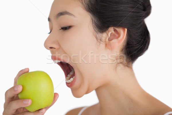 Woman biting into a green apple Stock photo © wavebreak_media