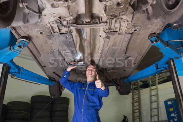 Repairman under car gesturing thumbs up Stock photo © wavebreak_media