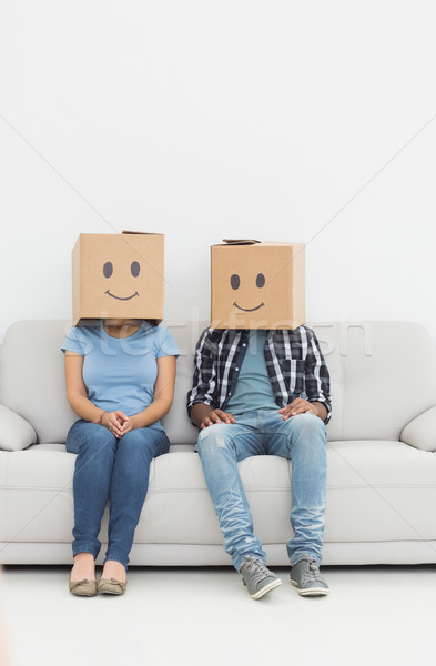 Young couple with happy smiley boxes over faces Stock photo © wavebreak_media