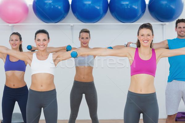 Fitness class exercising with dumbbells in gym Stock photo © wavebreak_media
