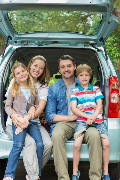 Happy family of four sitting in car trunk Stock photo © wavebreak_media