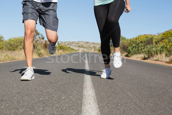 Fit couple running on the open road together Stock photo © wavebreak_media