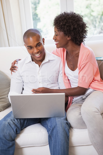 Stock photo: Happy couple relaxing on the couch with laptop