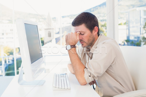 Bored casual businessman at his desk  Stock photo © wavebreak_media