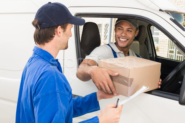 Delivery driver handing parcel to customer in his van Stock photo © wavebreak_media