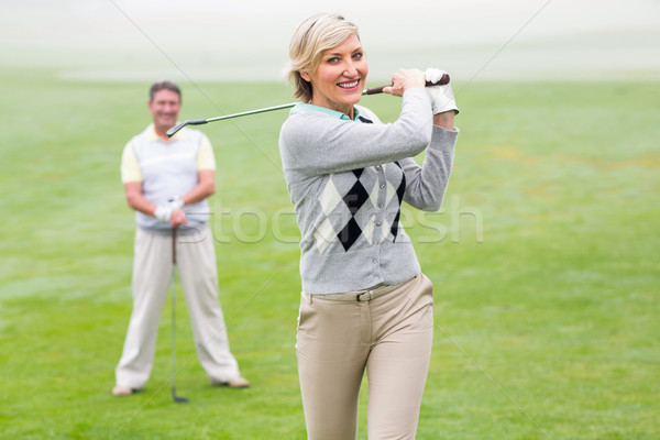 Lady golfer teeing off for the day watched by partner Stock photo © wavebreak_media