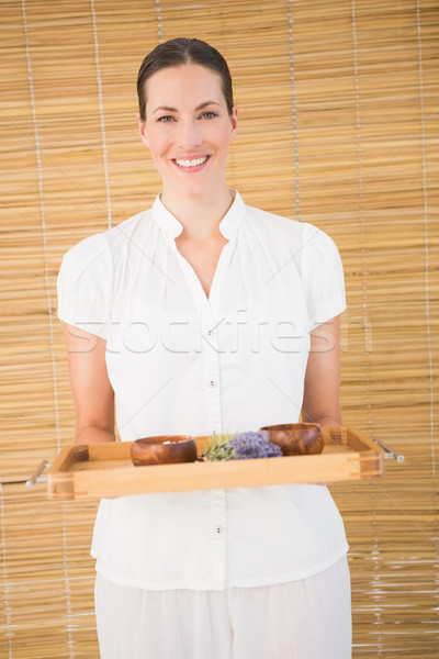 Smiling beauty therapist holding tray of beauty treatments Stock photo © wavebreak_media