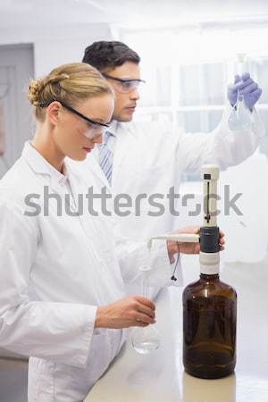 Scientists working attentively with beaker Stock photo © wavebreak_media