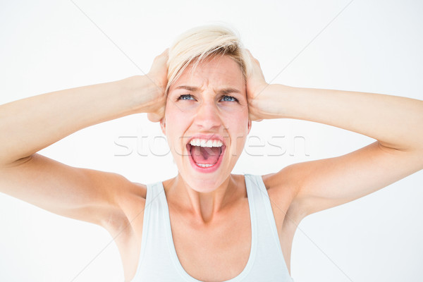 Angry blonde screaming and holding her head  Stock photo © wavebreak_media