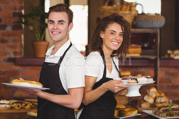 Souriant garçon serveuse plaques [[stock_photo]] © wavebreak_media