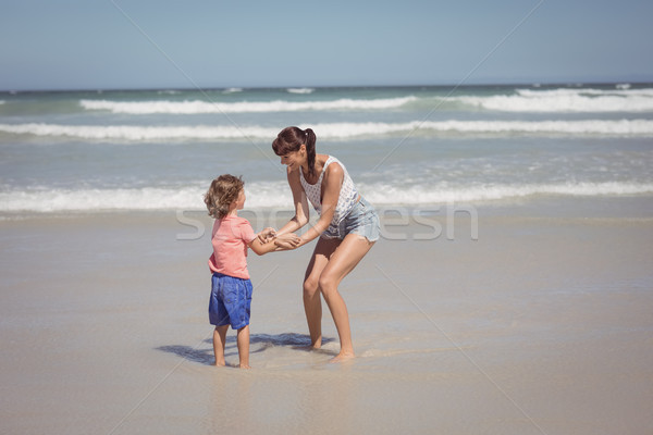 Happy son enjoying with mother on shore at beach Stock photo © wavebreak_media