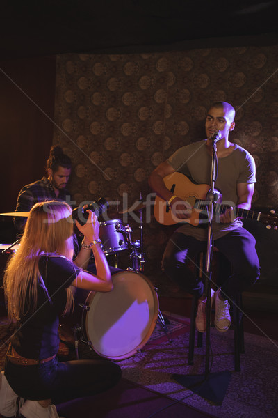 Woman photographing male singer in nightclub Stock photo © wavebreak_media