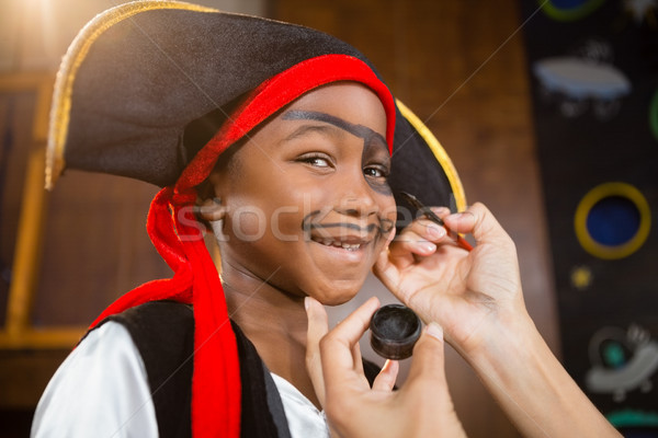 Hand of woman drawing on boy face Stock photo © wavebreak_media