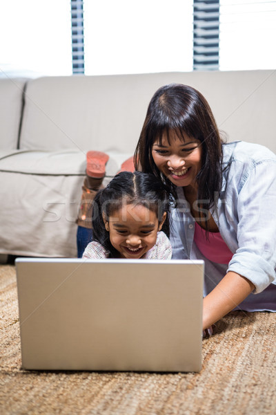 Stock photo: Happy young mother using laptop with her daughter