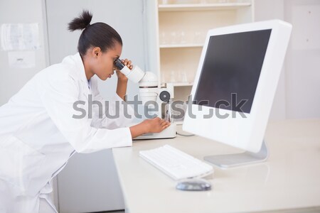 Side view of dentist working while sitting by computer Stock photo © wavebreak_media