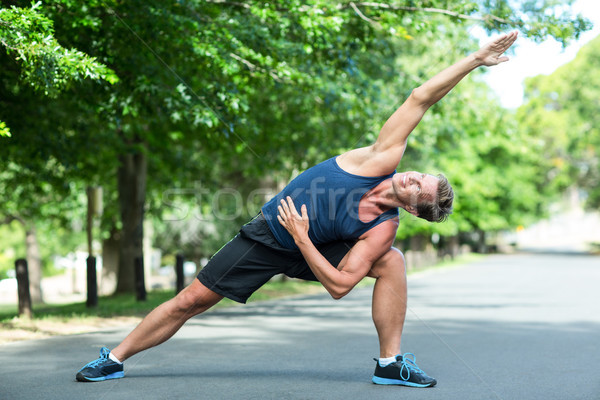 Sportsman stretching in park Stock photo © wavebreak_media