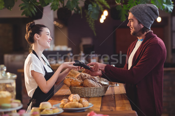 Smiling customer paying with credit card  Stock photo © wavebreak_media