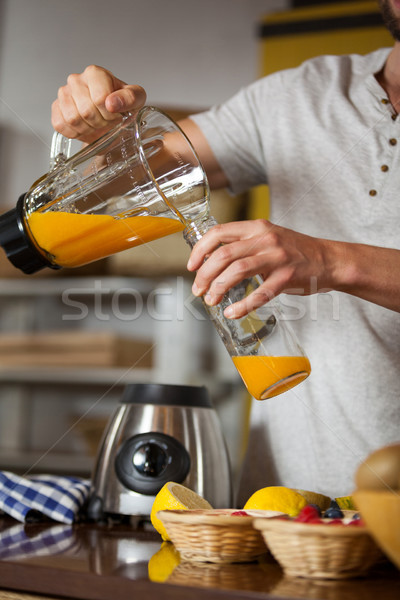 Male staff pouring juice in a bottle Stock photo © wavebreak_media