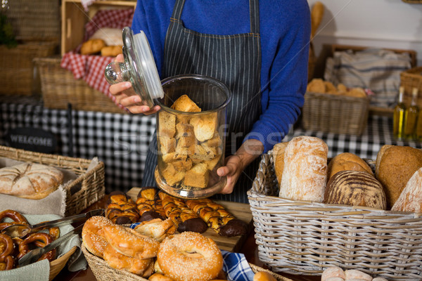 Mid section of staff holding glass jar of cookies at counter Stock photo © wavebreak_media