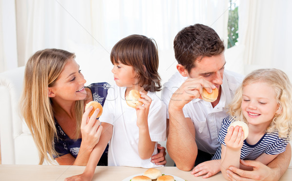 Lively family eating burgers in the living room Stock photo © wavebreak_media