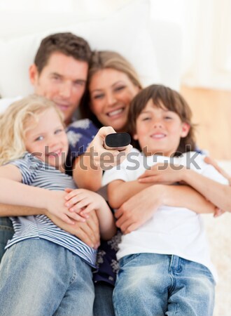 Caucasian family watching television sitting on sofa Stock photo © wavebreak_media