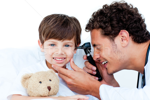 Smiling doctor examining patient's ears Stock photo © wavebreak_media