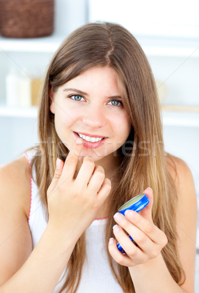 Radiant woman using cosmetic cream in a bathroom Stock photo © wavebreak_media