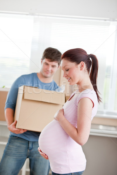 adorable future mother with husband standing in their new house unpacking in the kitchen Stock photo © wavebreak_media