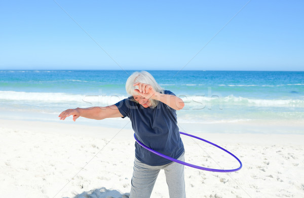 Stock photo: Senior woman playing with her hoop