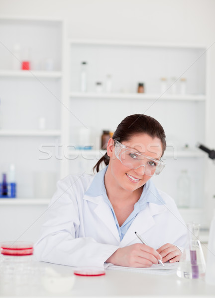 Stock photo: Portrait of a cute scientist preparing a report looking at the camera